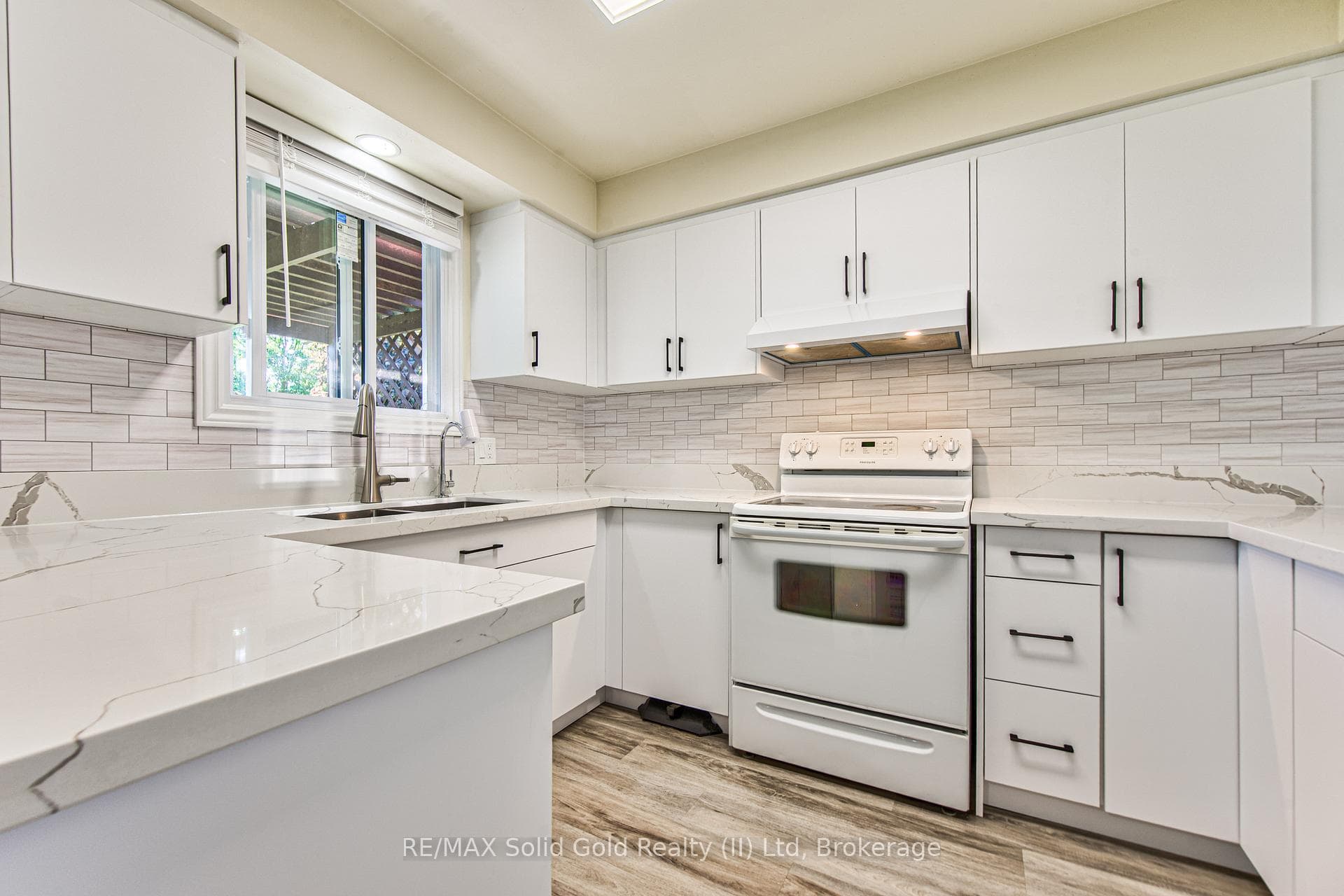 Quartz surface counters and tasteful backsplash.