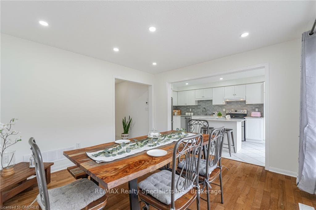 Dining space with sink and light hardwood / wood-s