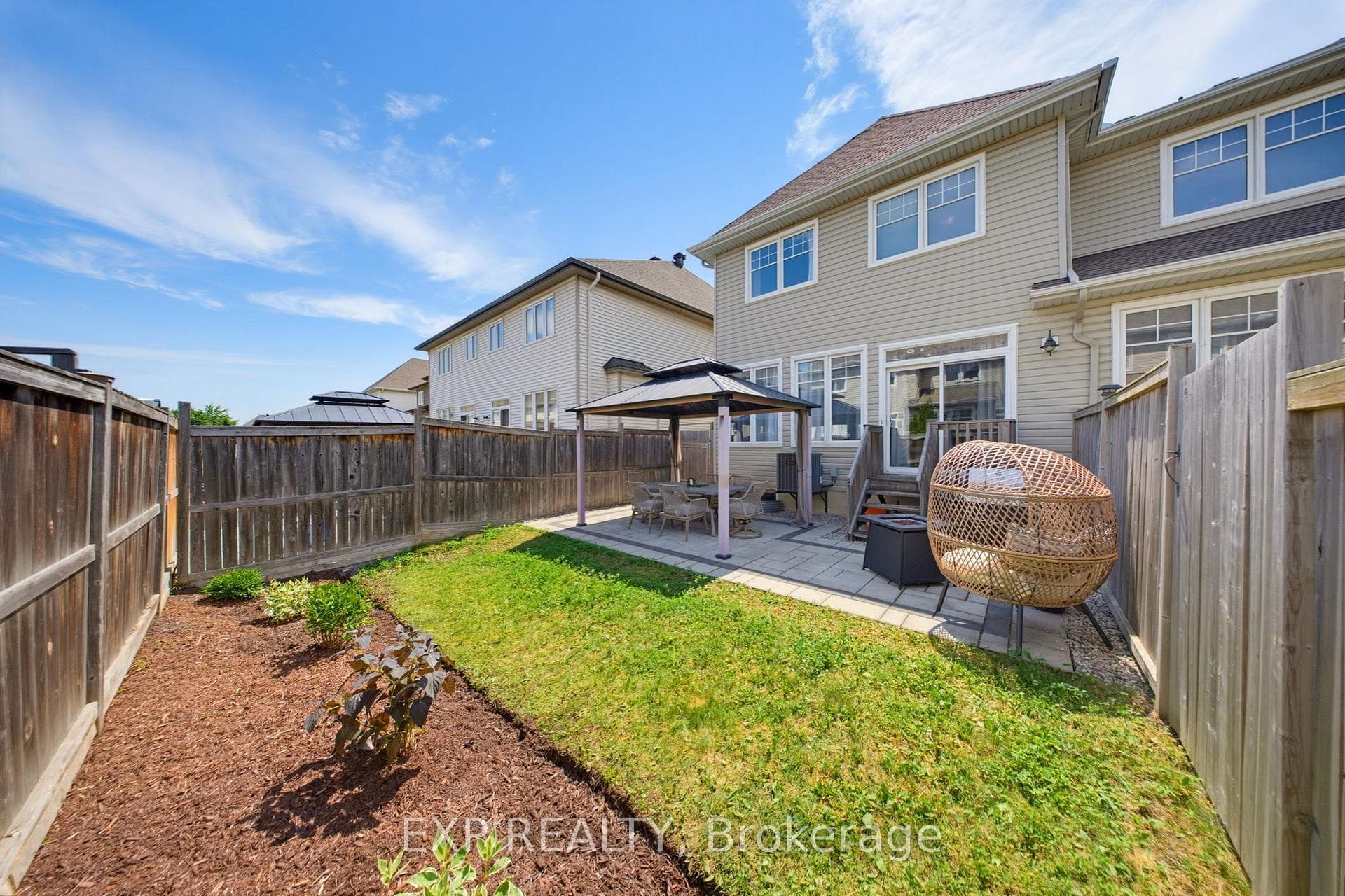 Fully Fenced Backyard With Lawn And Patio.