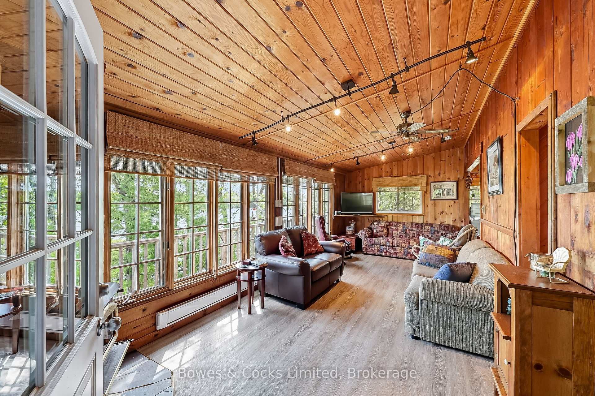 Living room with wall of windows facing lake