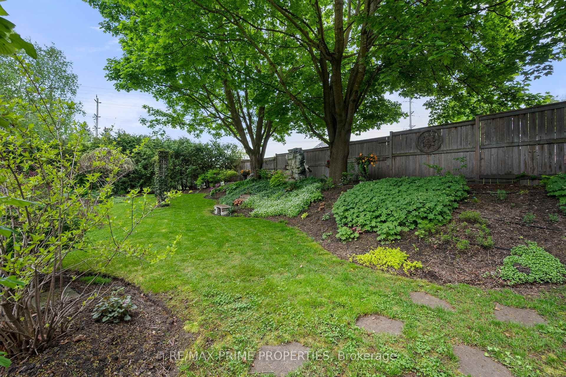 Lush gardens shaded by maples