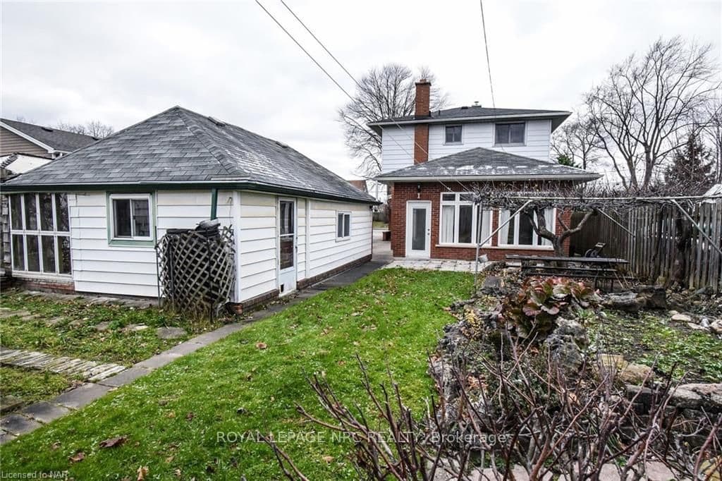 Back view of house and detached garage.