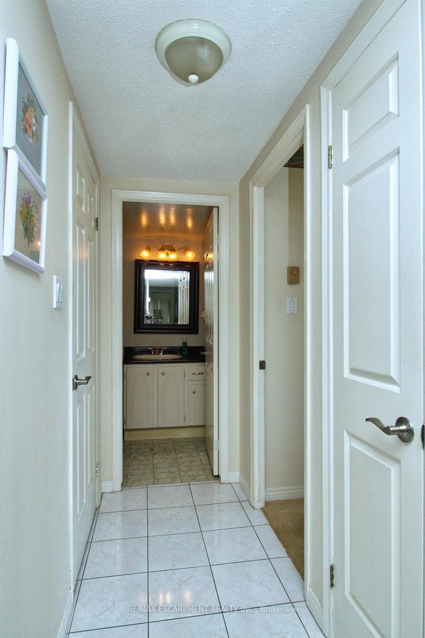 Hallway from foyer towards 2 bedrooms and bath