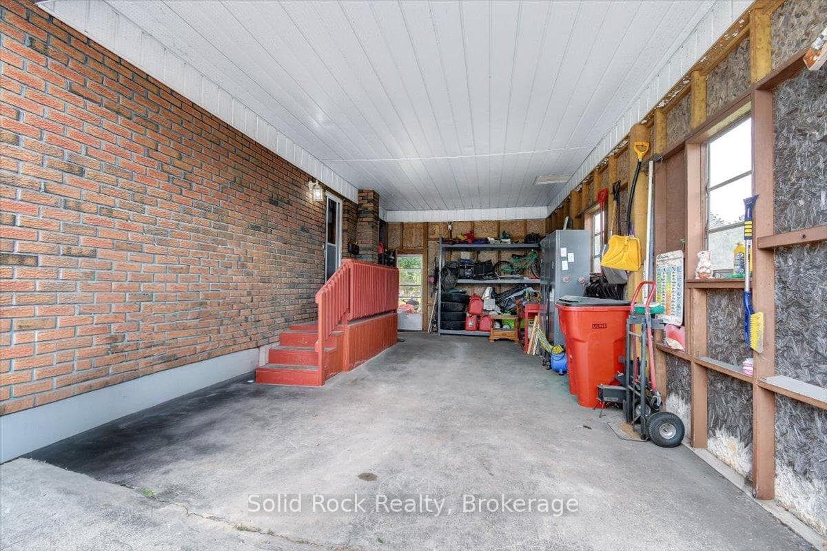 Carport/garage entrance into kitchen and backyard.
