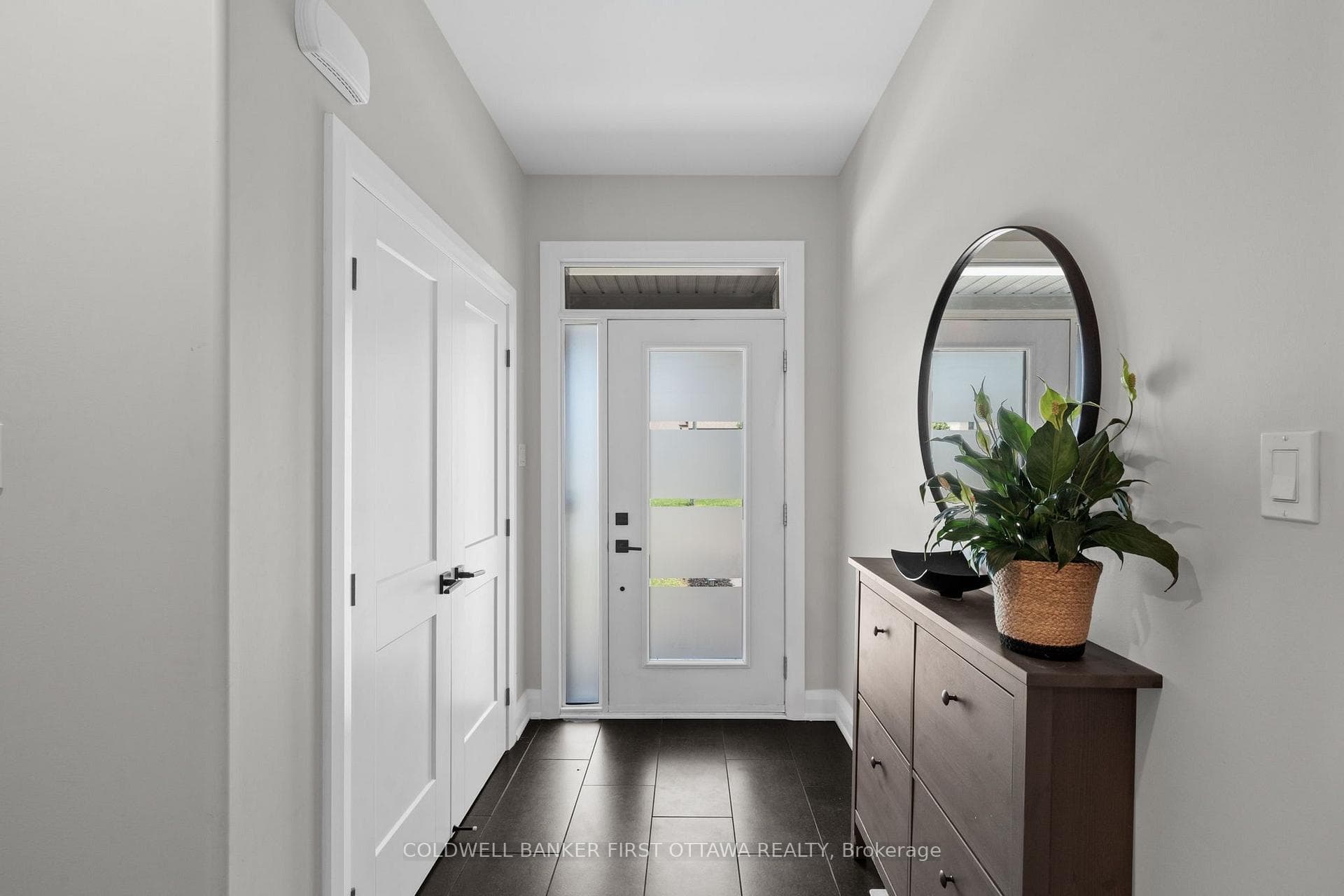 Tiled front foyer w dbl door hall closet.
