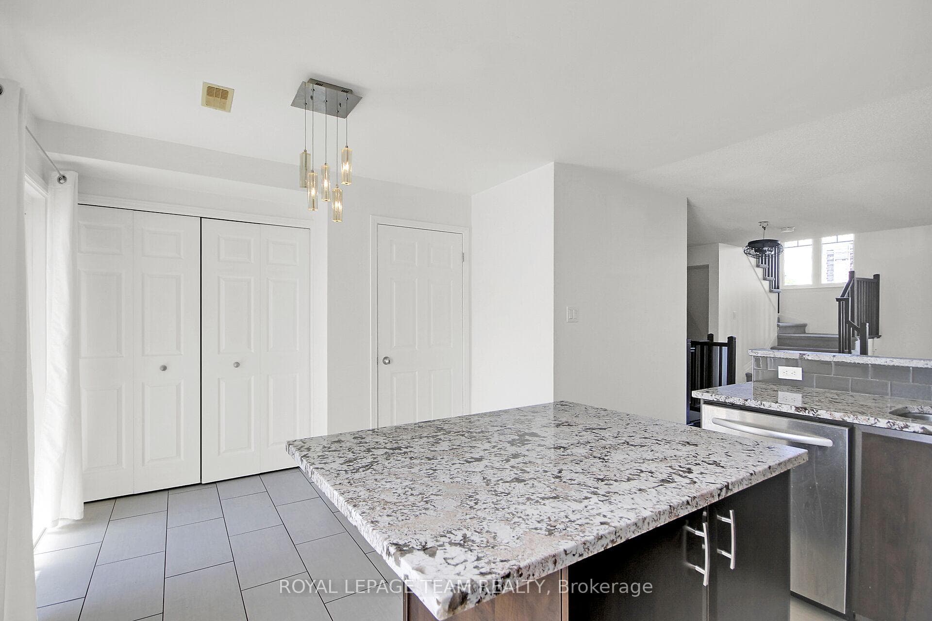 Large island in tiled Kitchen.