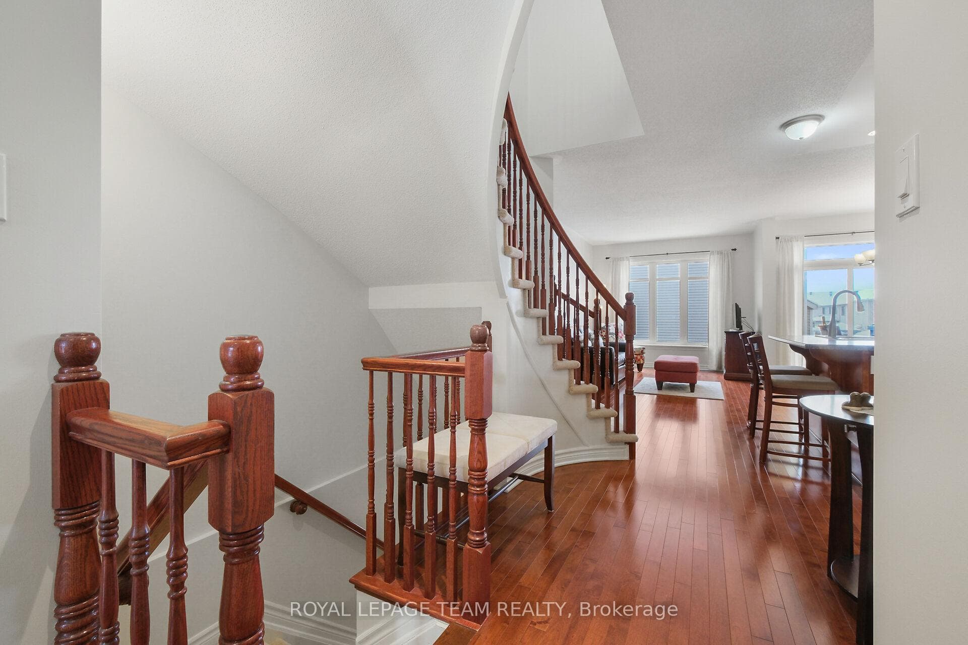 Hallway w/HDW leads to open concept living space.