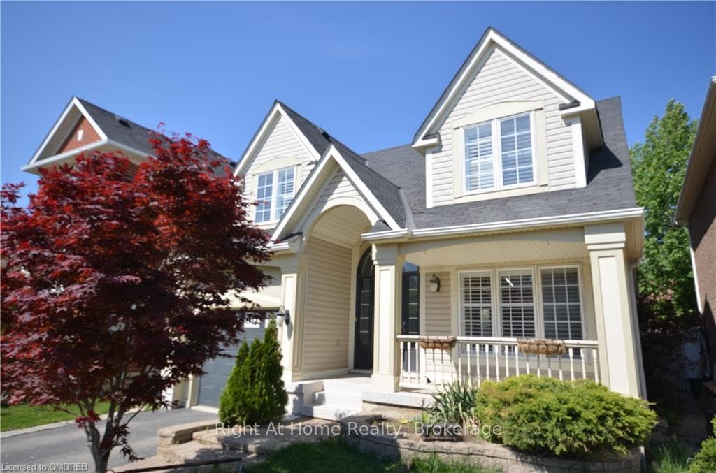 View of front of house featuring a garage and a po