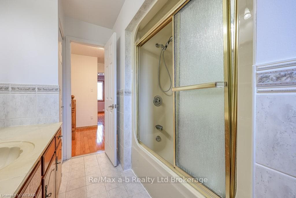 Bathroom with tile patterned floors, vanity, bath