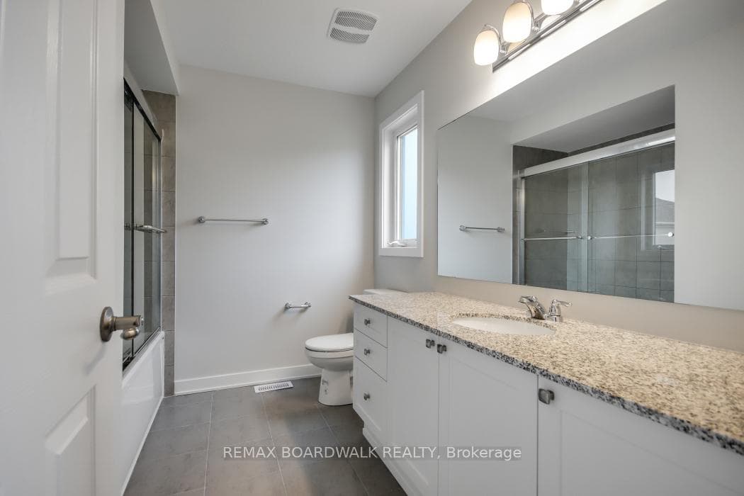 Ensuite washroom with granite counters