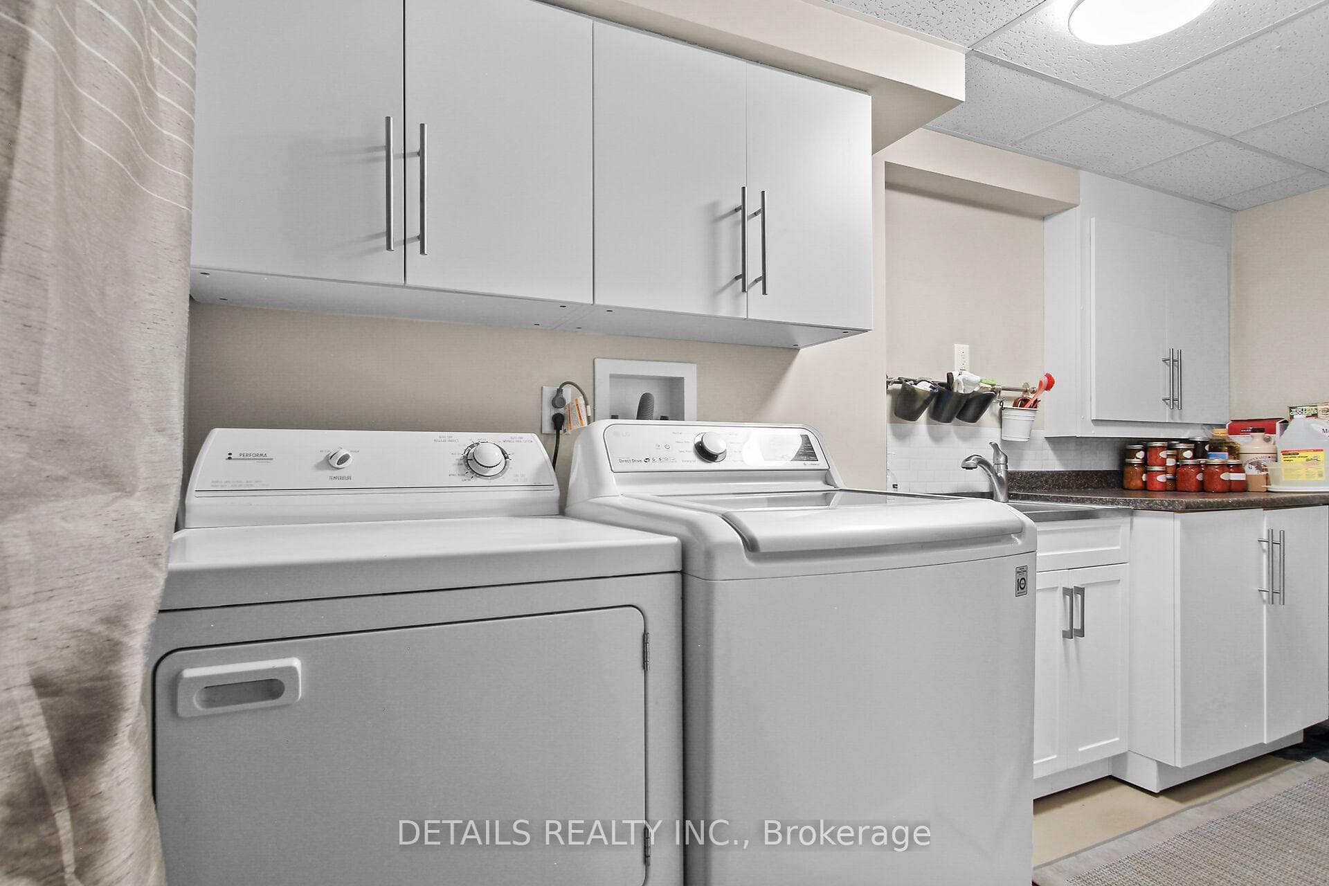 Laundry are with plenty of storage cabinets