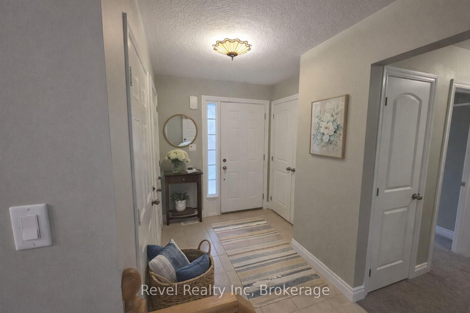 foyer with inside entry to the garage (staged)