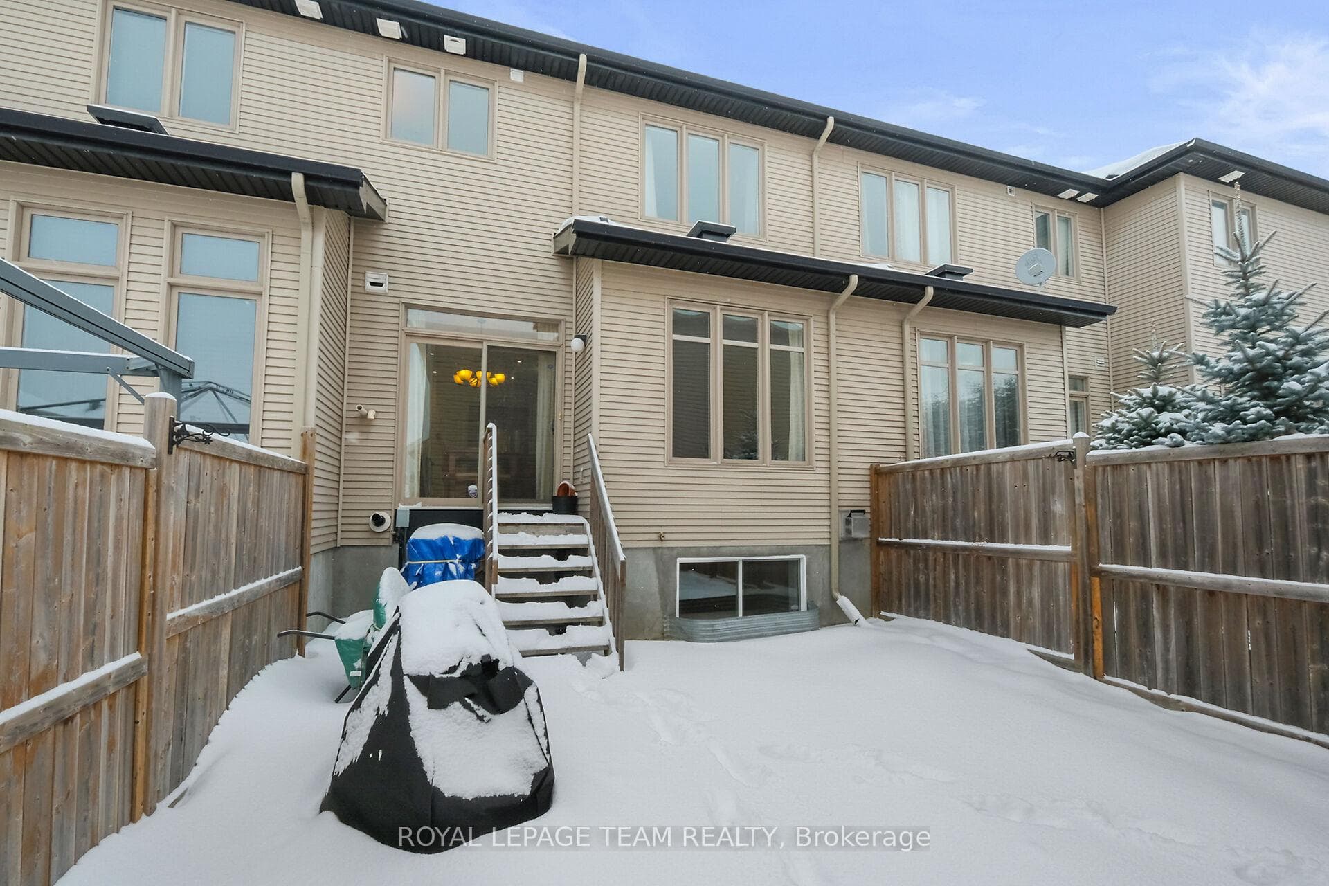 Patio doors lead to fully fenced yard.