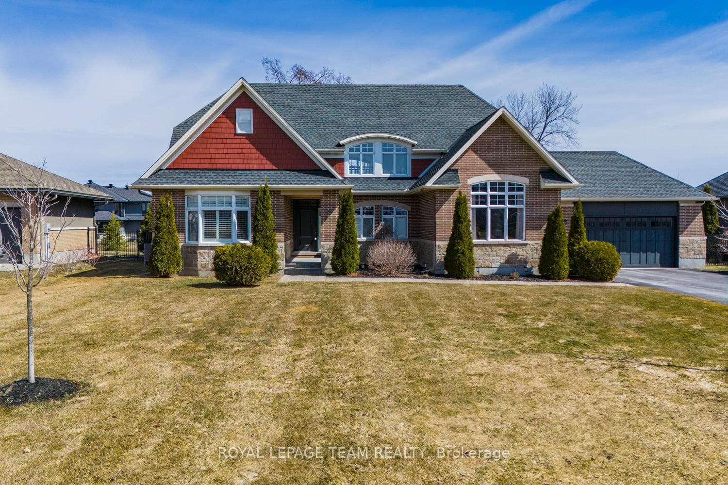 Spacious front lawn with mature landscaping.