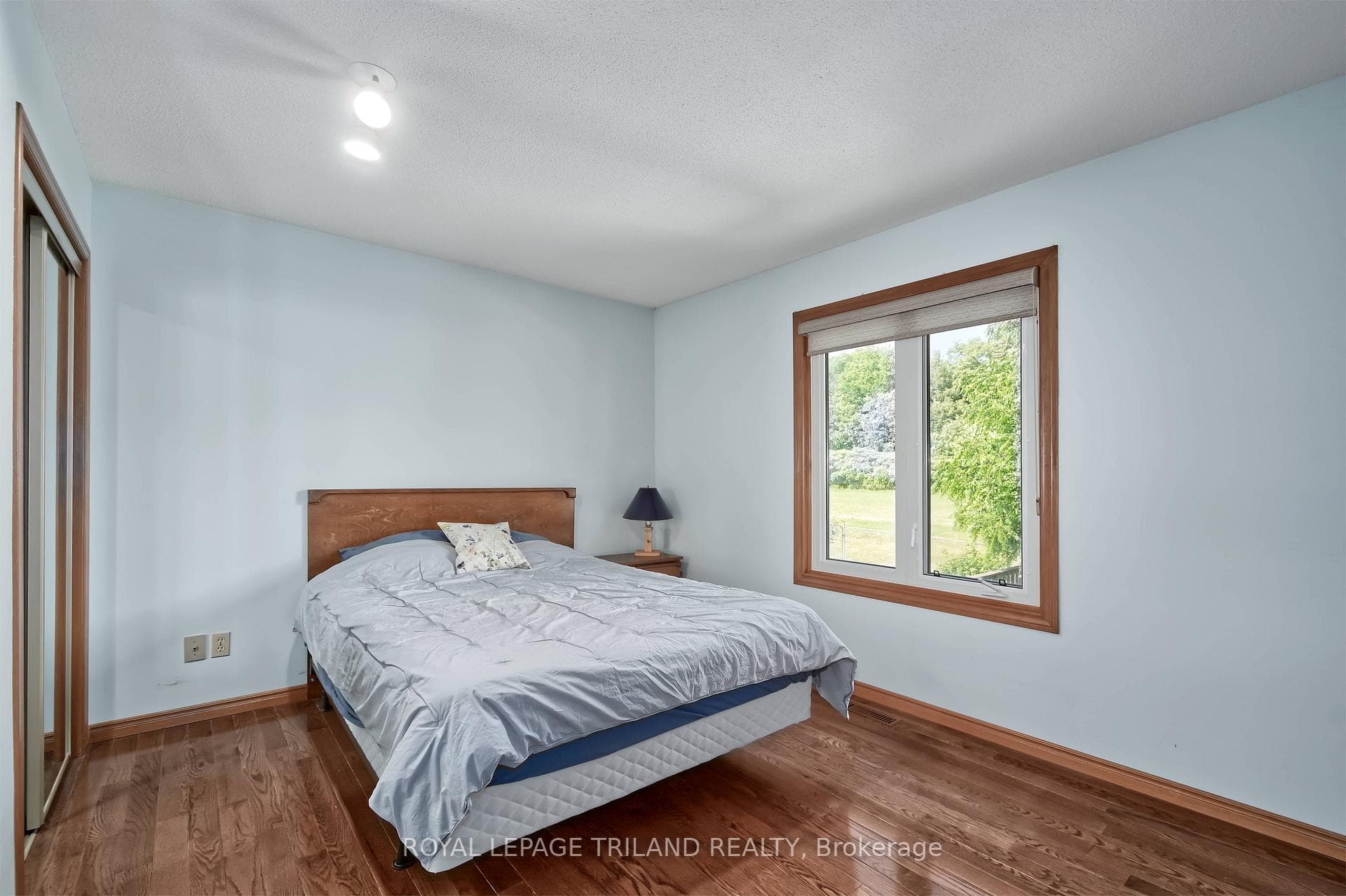 spacious main floor bedroom with hardwood floors