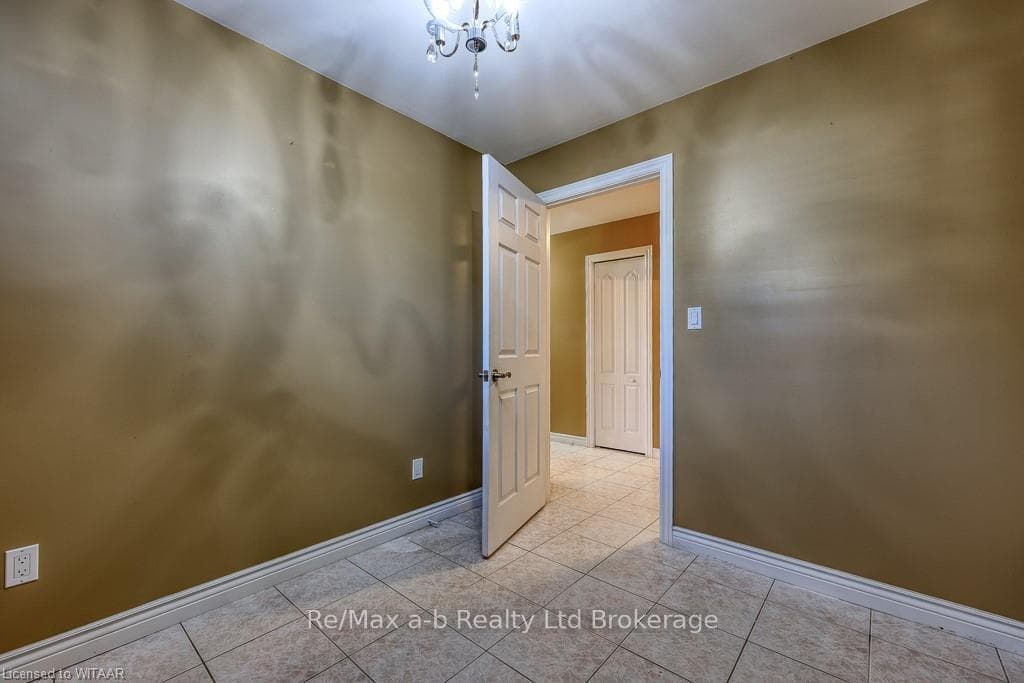 Unfurnished room featuring a chandelier and light