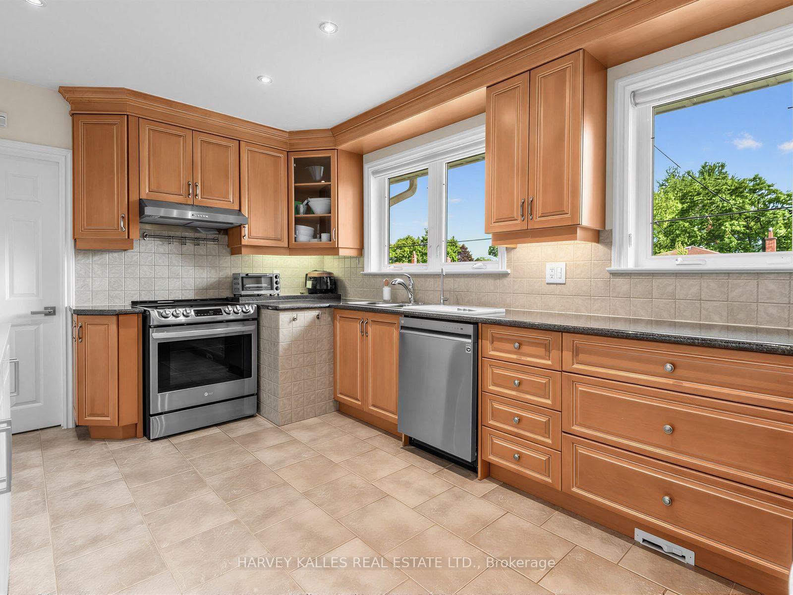 Kitchen with windows facing backyard