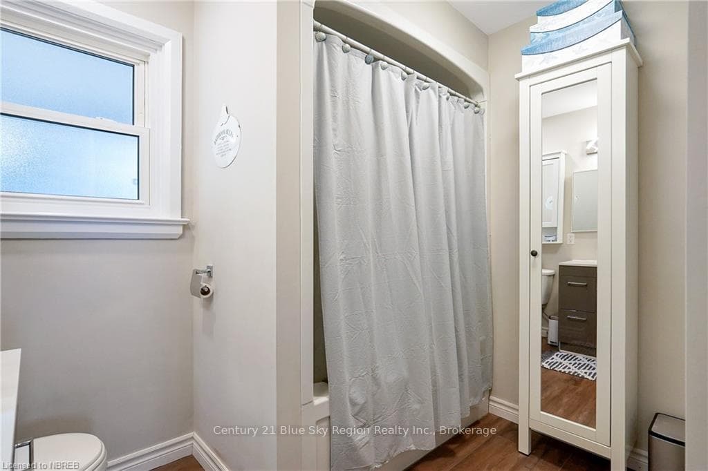 Bathroom with walk in shower, toilet, vanity, and