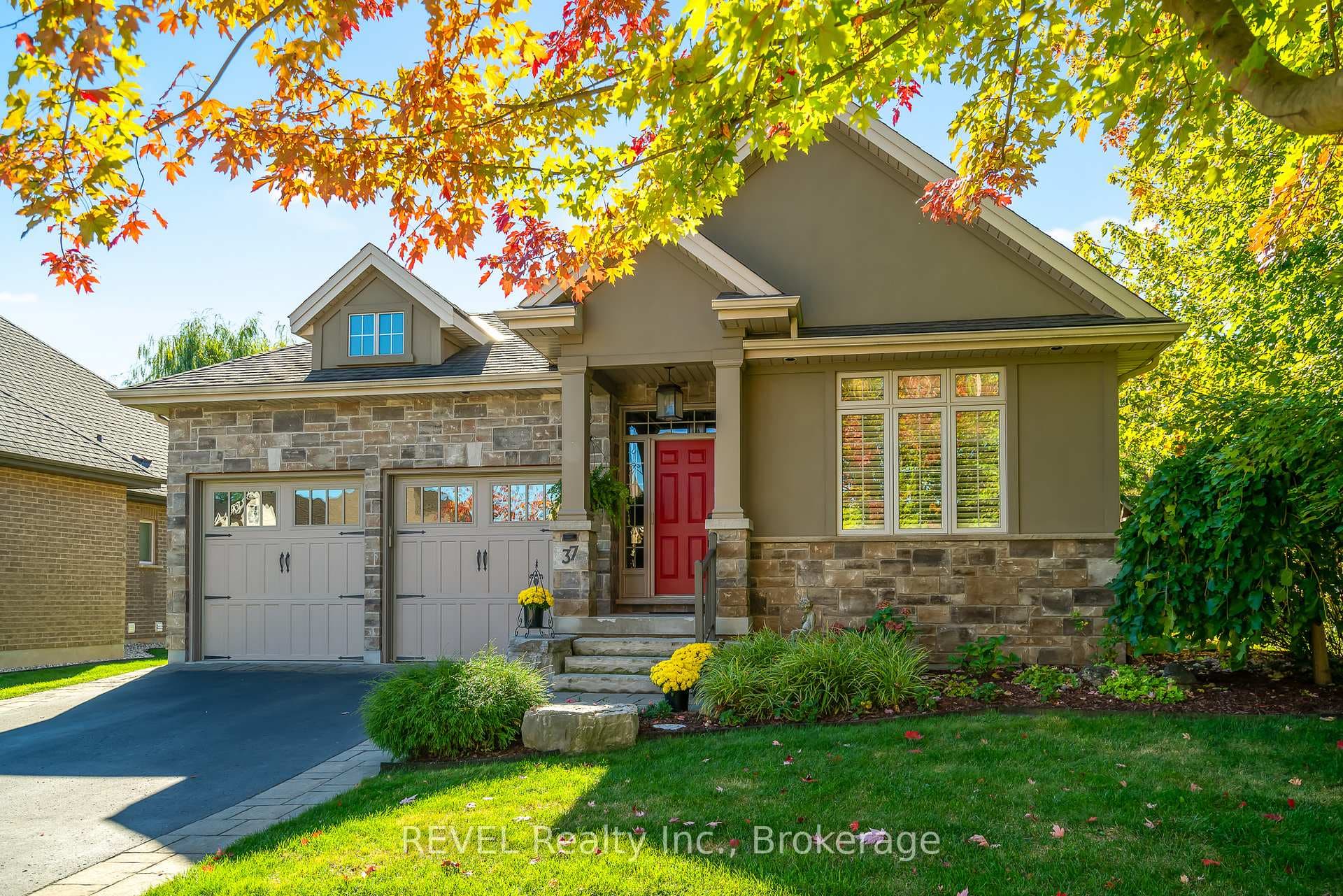 Luxury bungalow with stone, brick, and stucco.