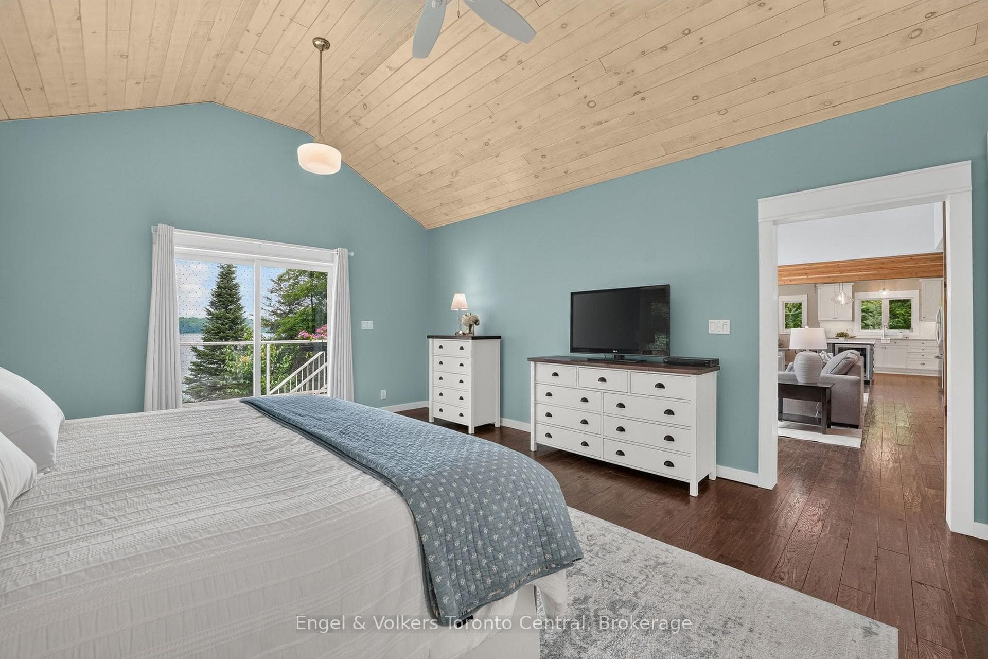 Primary bedroom with lake view and w/o to deck