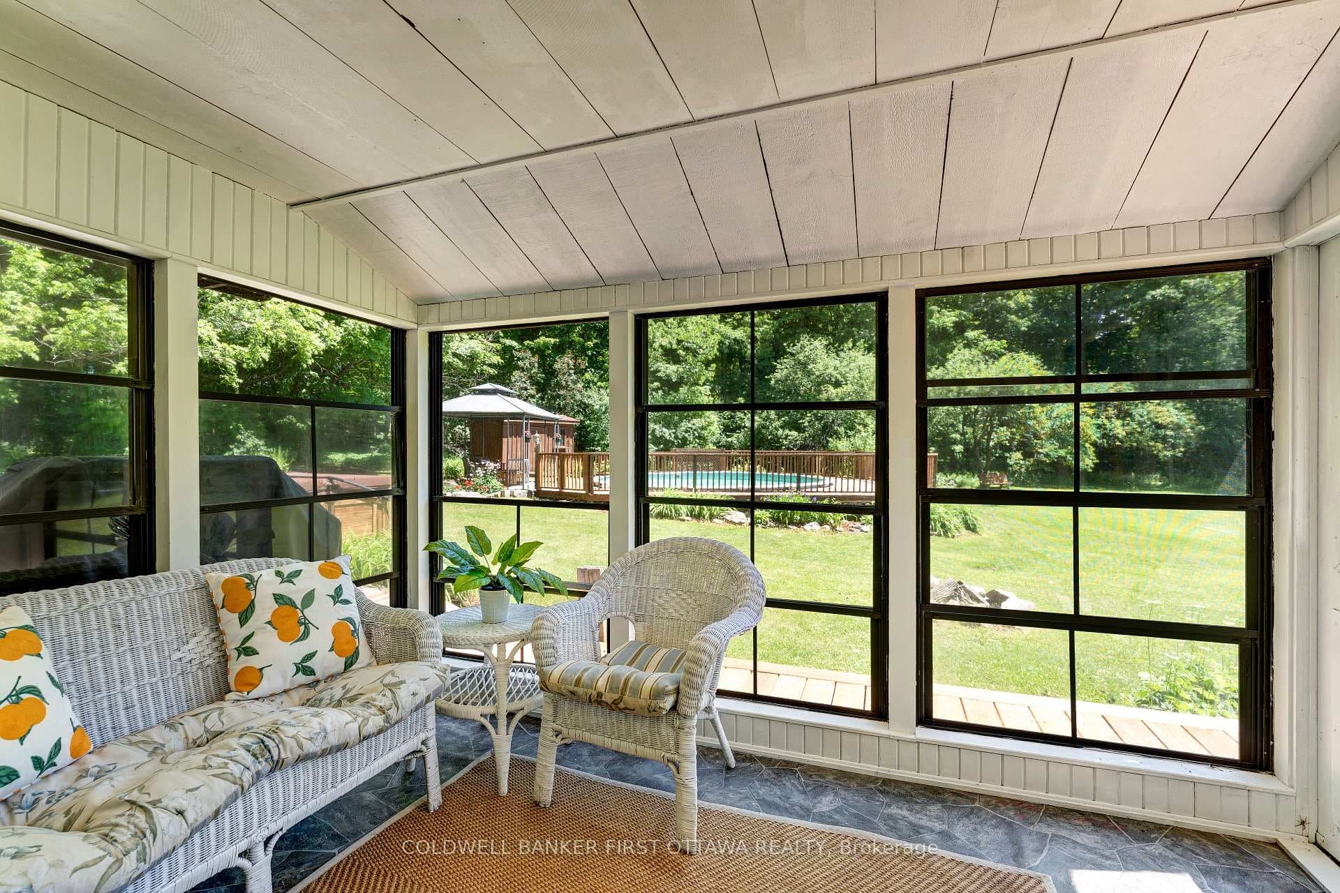 Sunroom overlooks gardens and pool