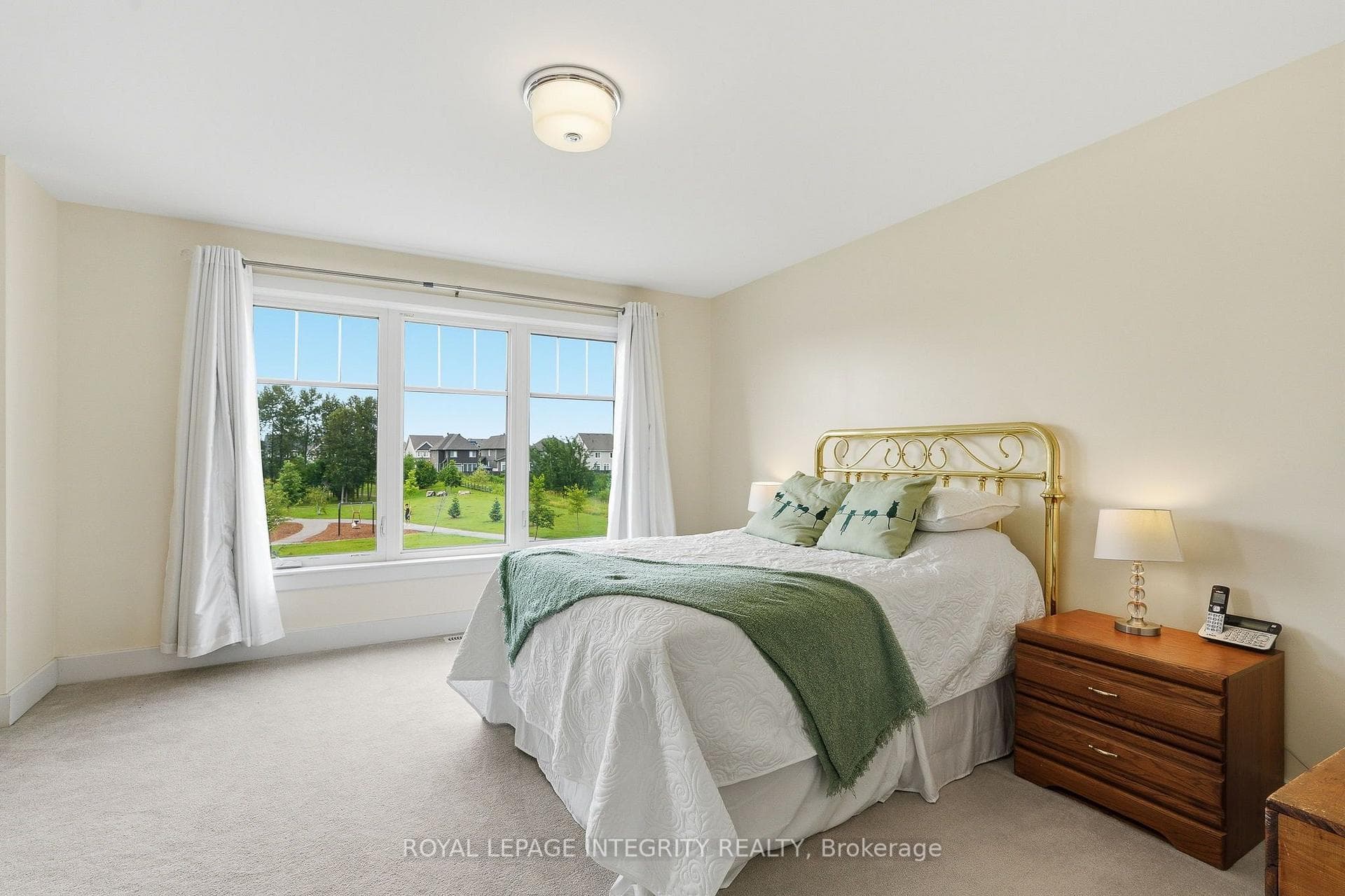 The primary bedroom with a view of Anishà Park