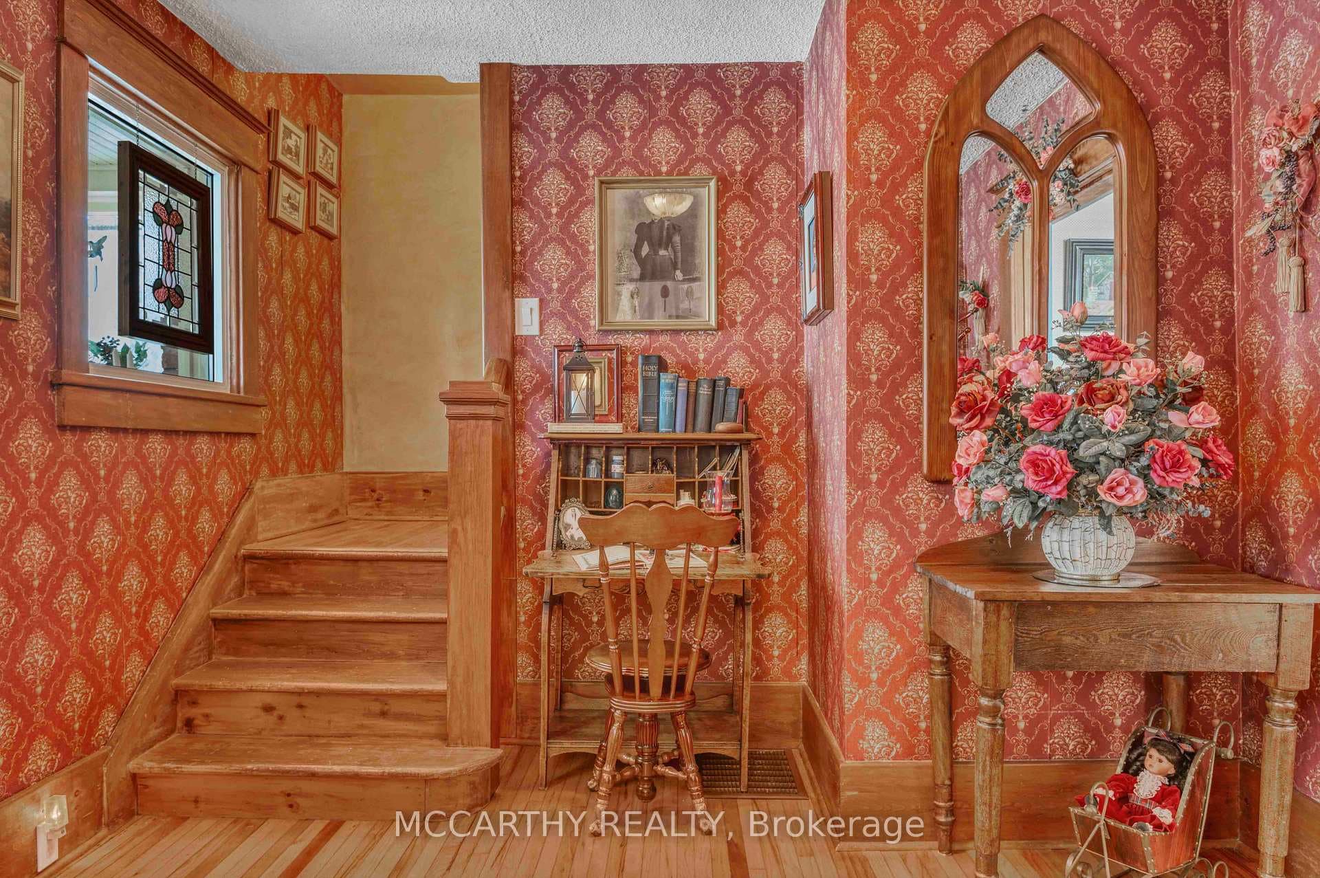 Foyer with wooden floors and stairs