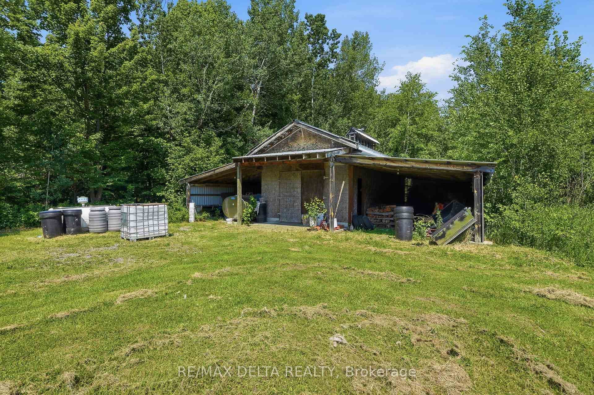 Sugar shack with metal roof and double lean-to.