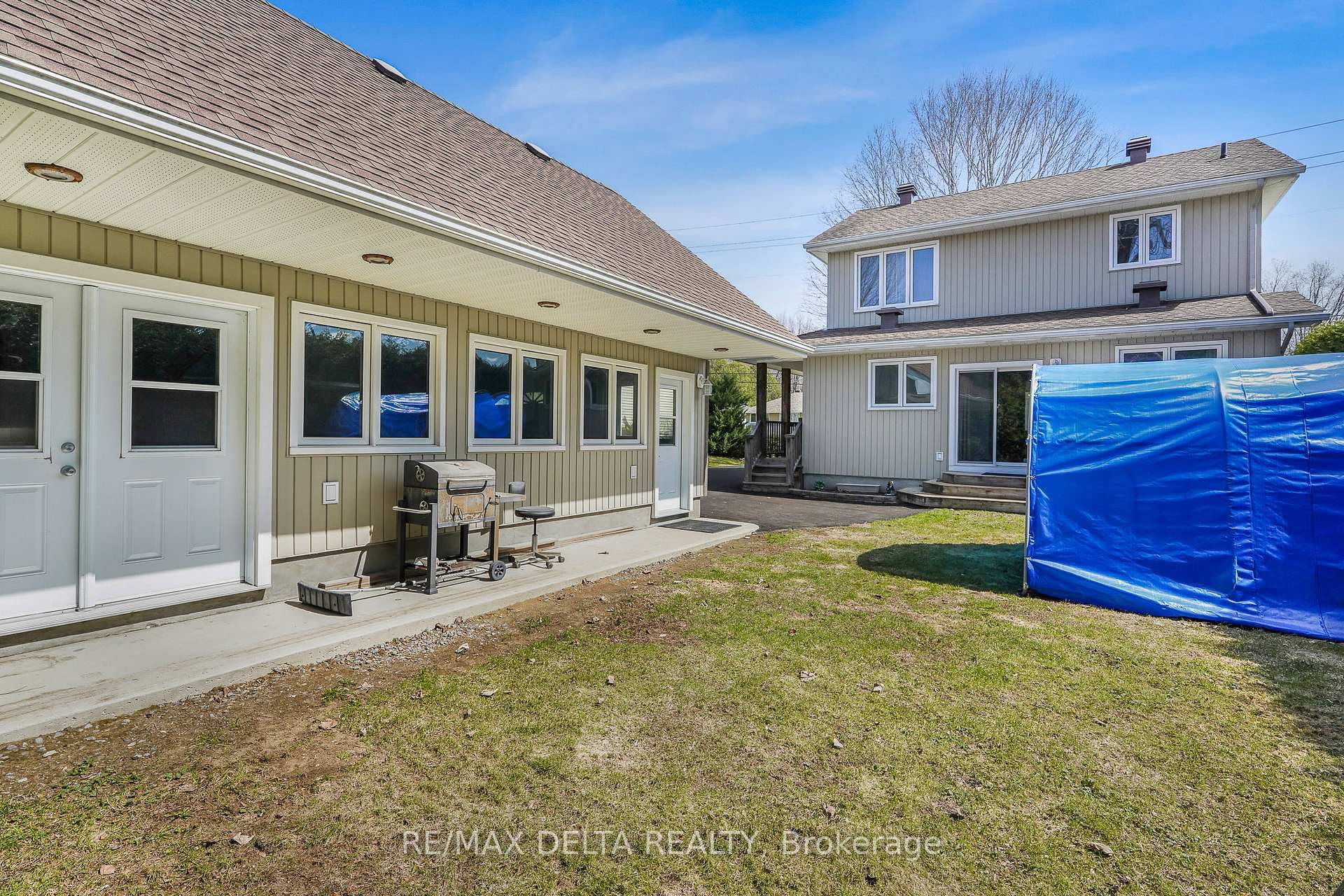 Garden doors and covered concrete pad.