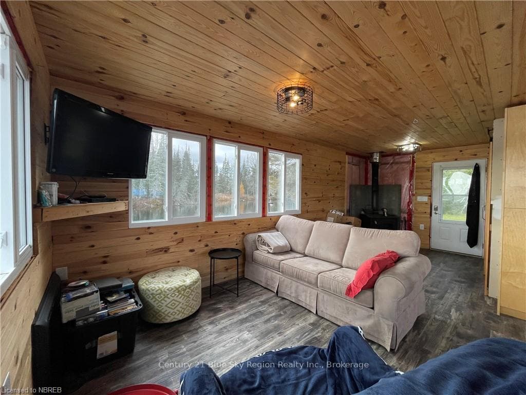 Bunkie Living room with wooden ceiling, a wealth o