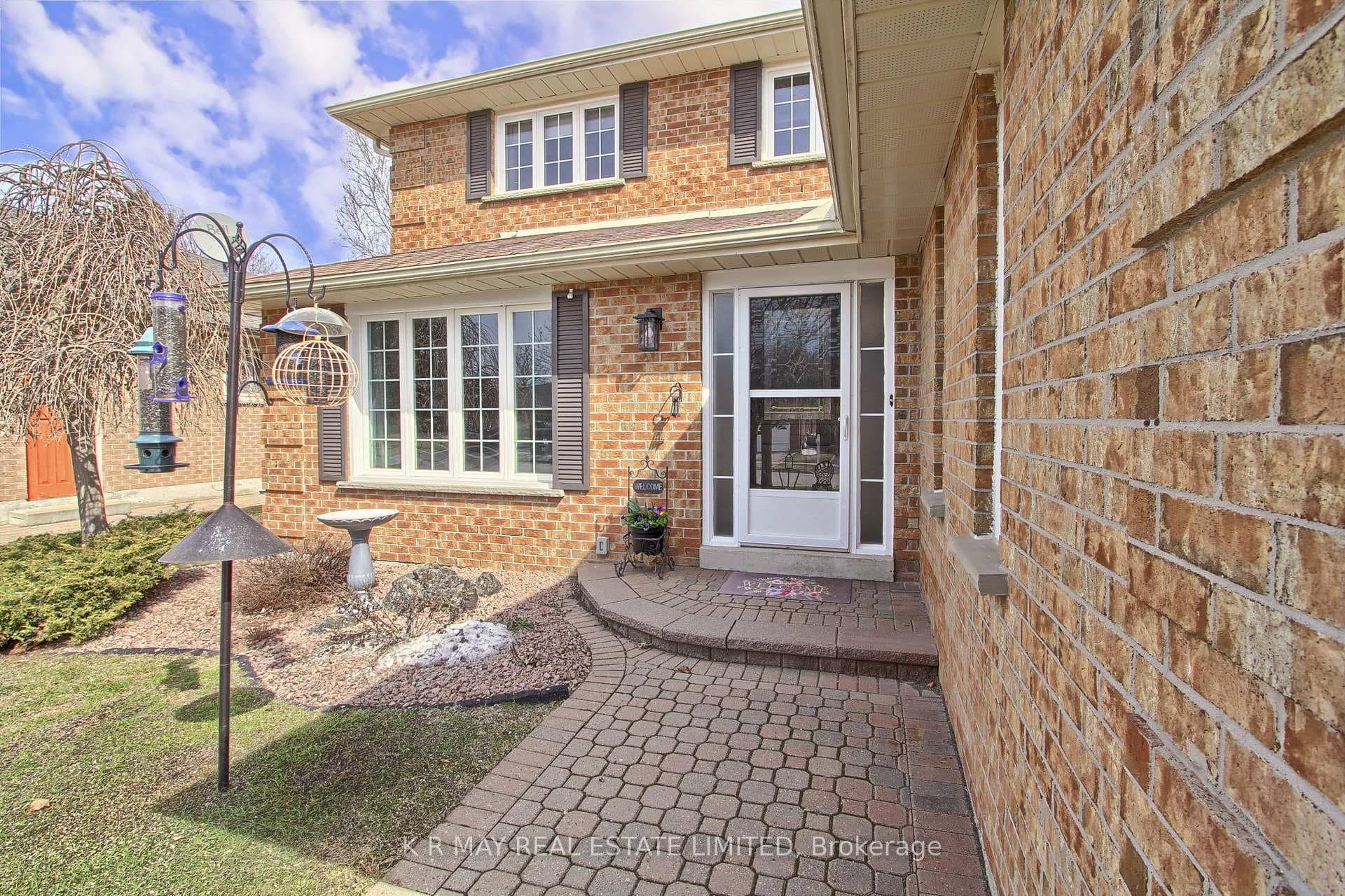 2 storey brick home with front & sideyard walkways