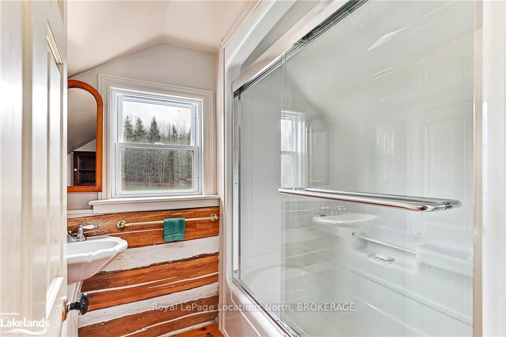 Bathroom with bath / shower combo with glass door,
