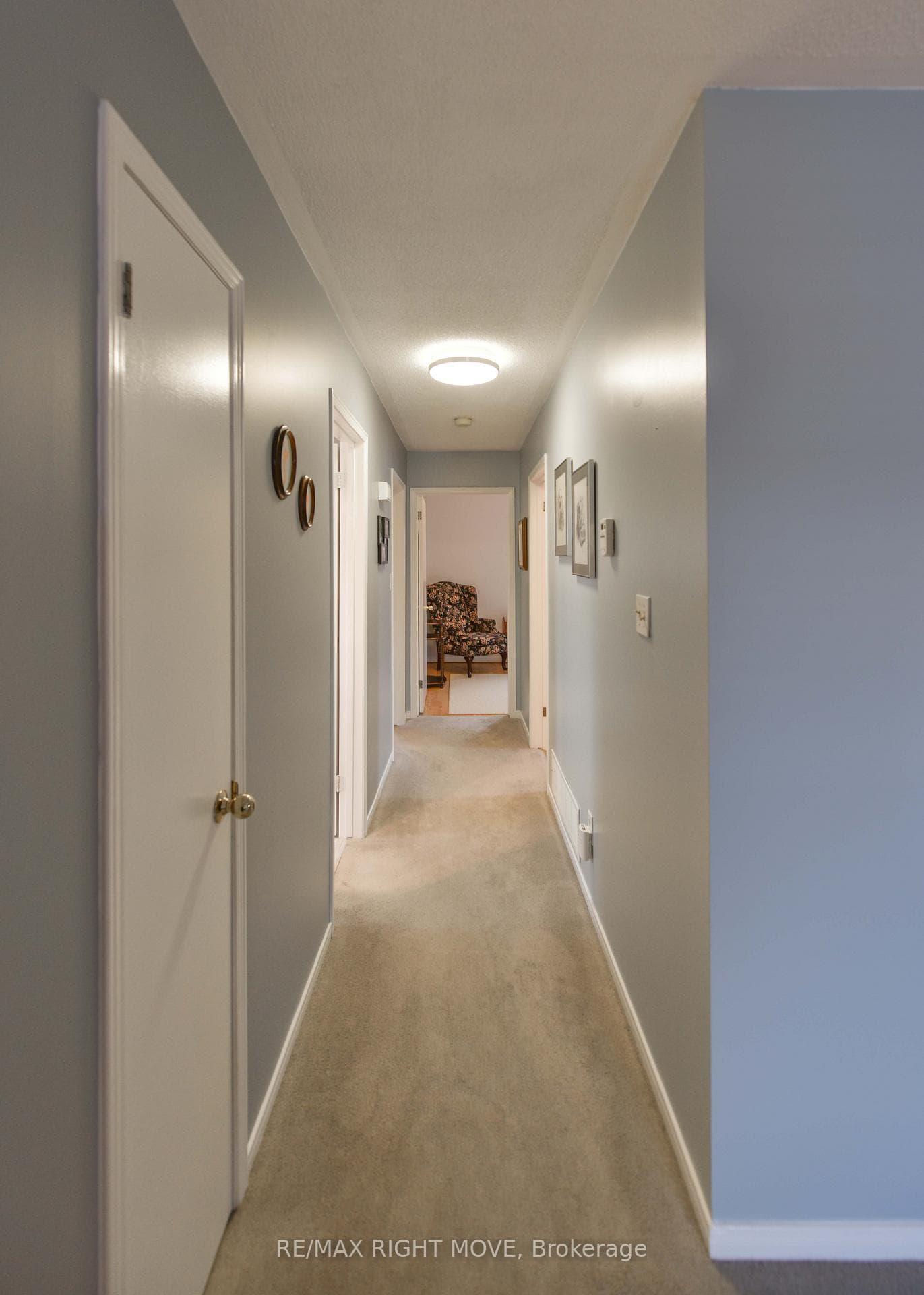 Main floor hallway leading to 3 bedrooms