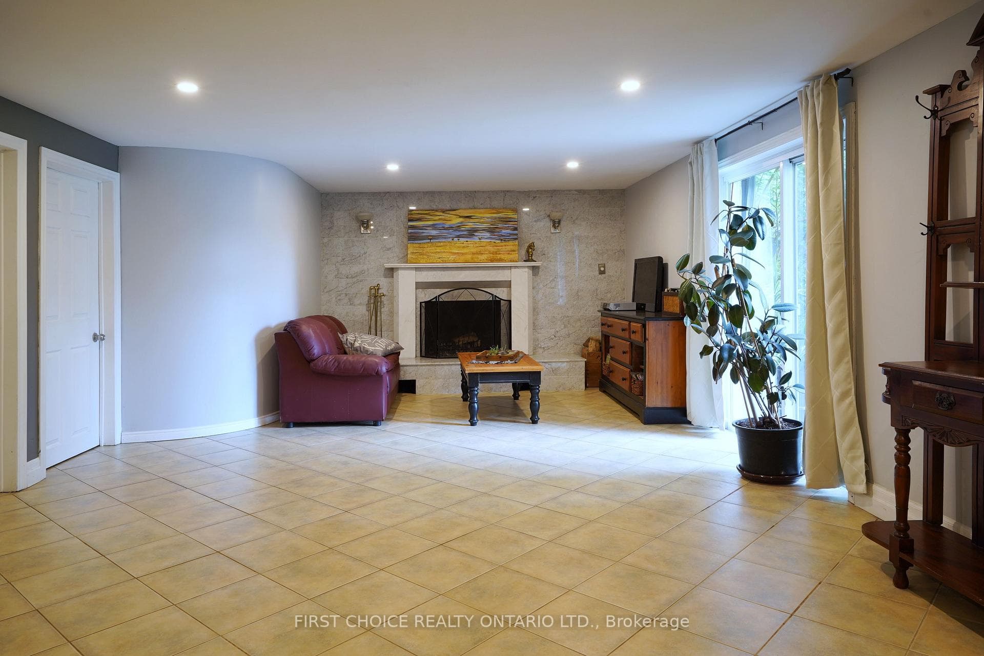 Huge recreation room with fireplace, patio door.