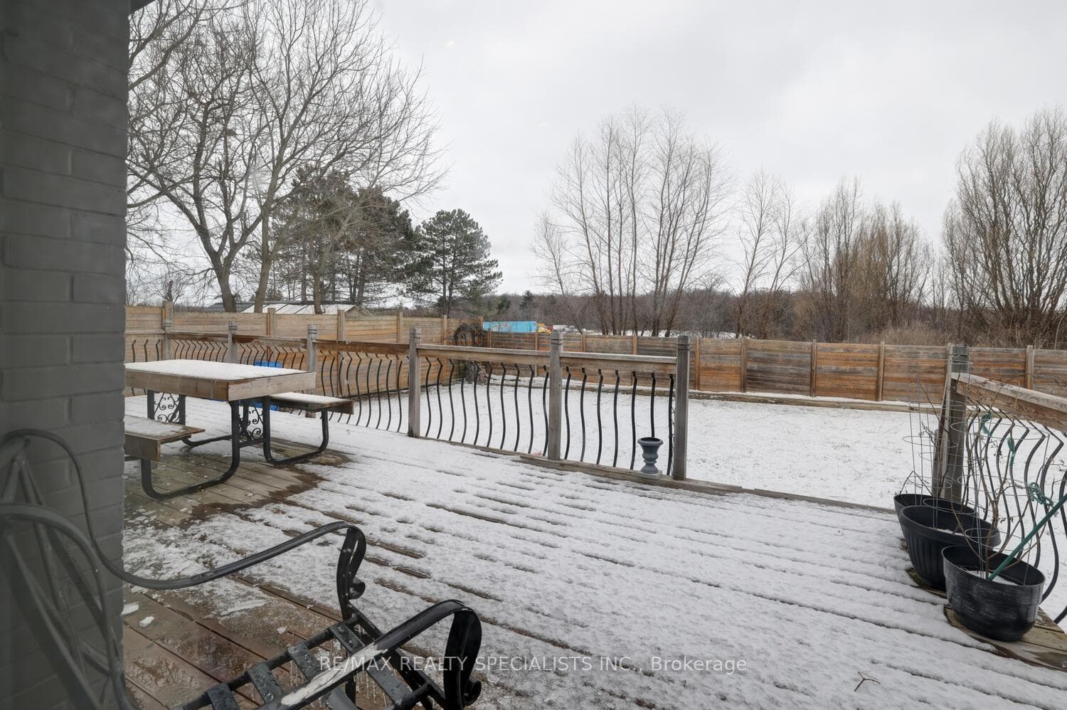 Large deck overlooking lawn and pool.