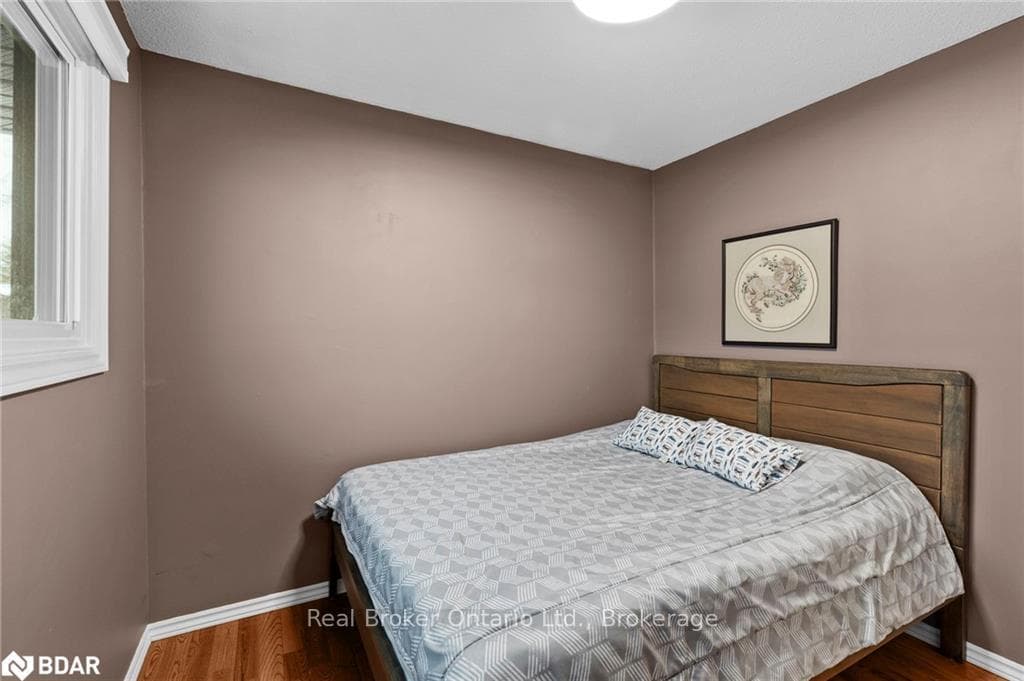 Bedroom with dark hardwood / wood-style floors