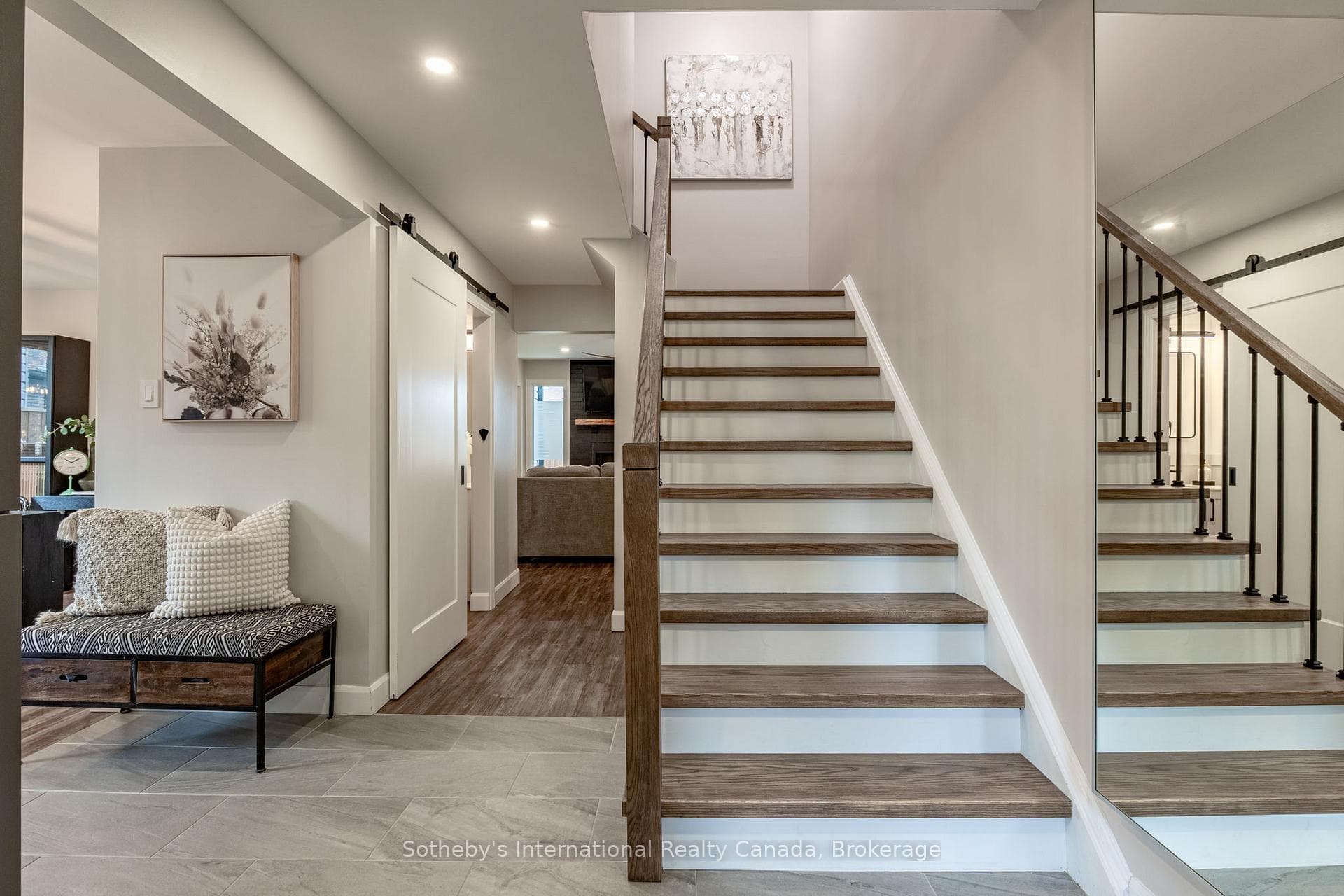 Elegant red oak staircase w/black iron railings.
