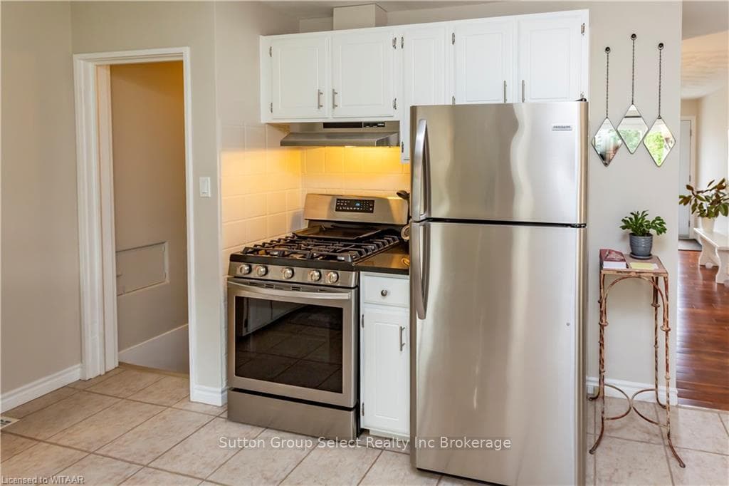 Kitchen featuring light wood-type flooring, tastef