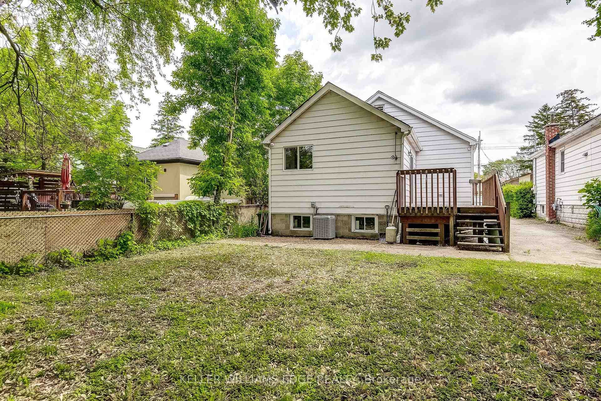 Rear view of property with a deck and stairs