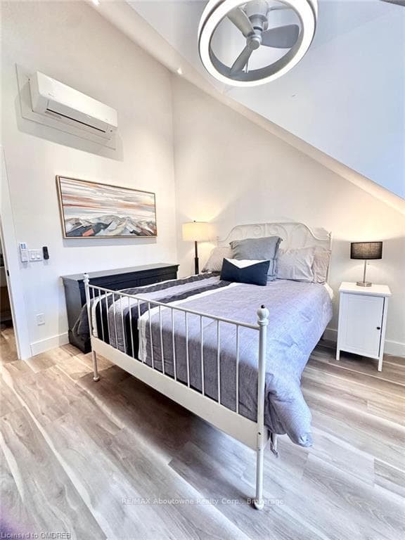 Bedroom featuring ceiling fan, light wood-type flo