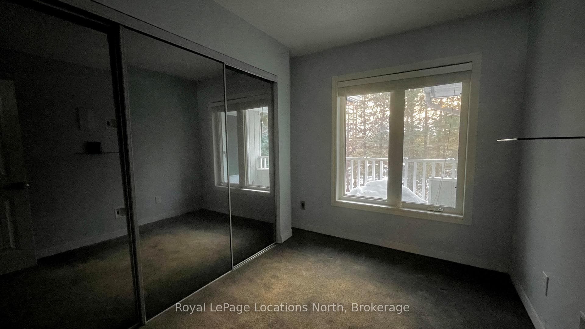 Bedroom with wall to wall mirrored closet
