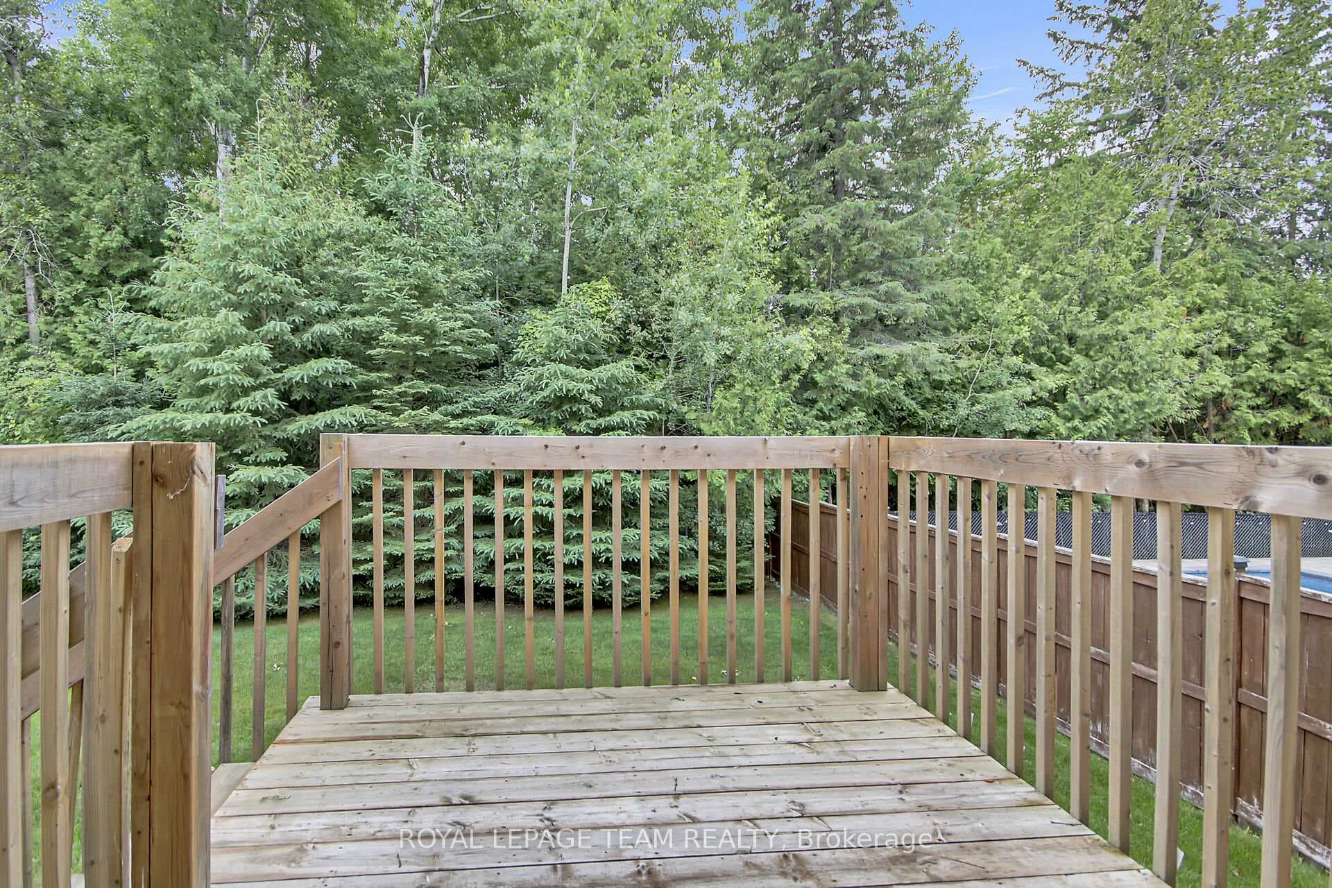 Spacious rear deck overlooking your treed backyard