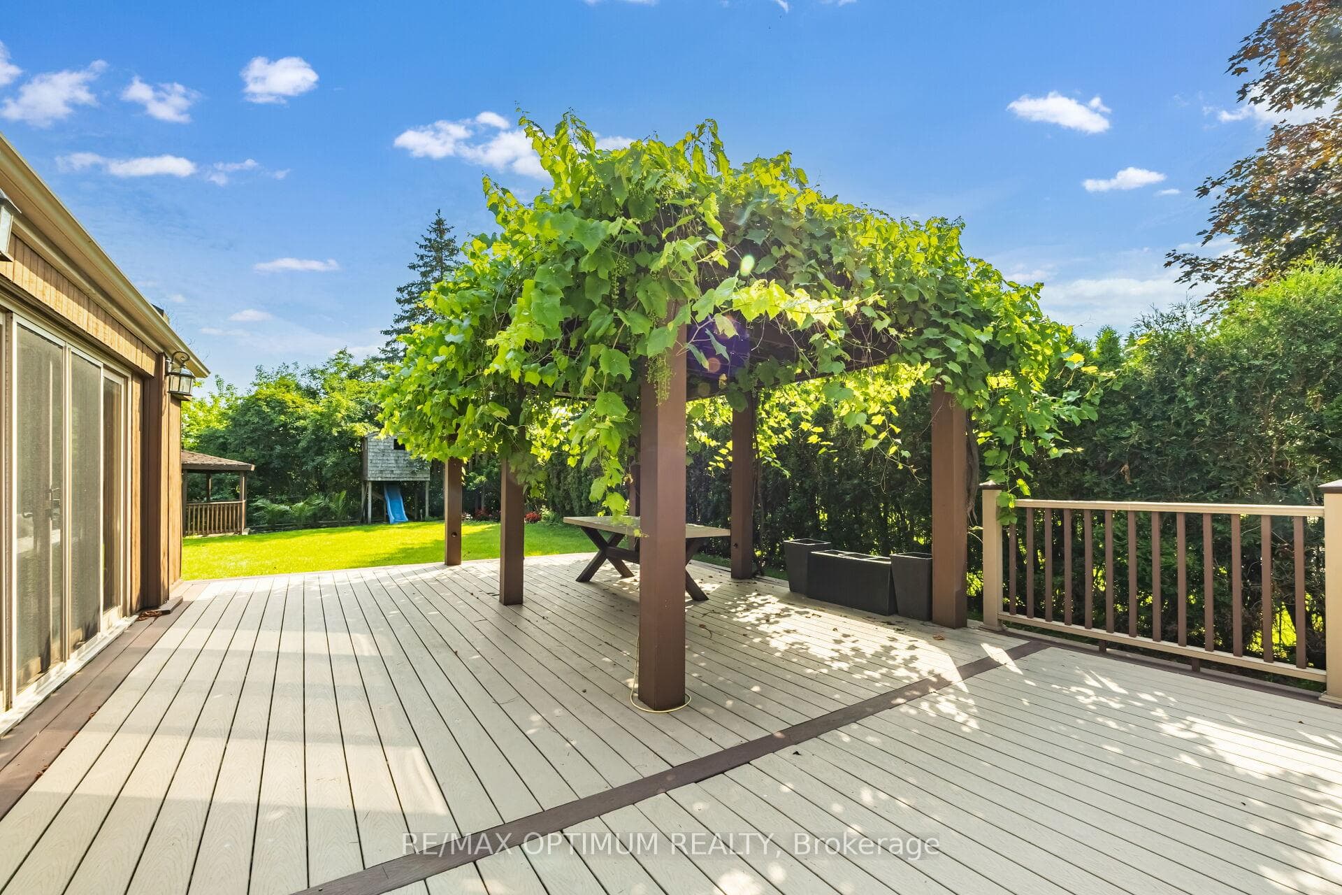 Grapevine-covered pergola & composite deck
