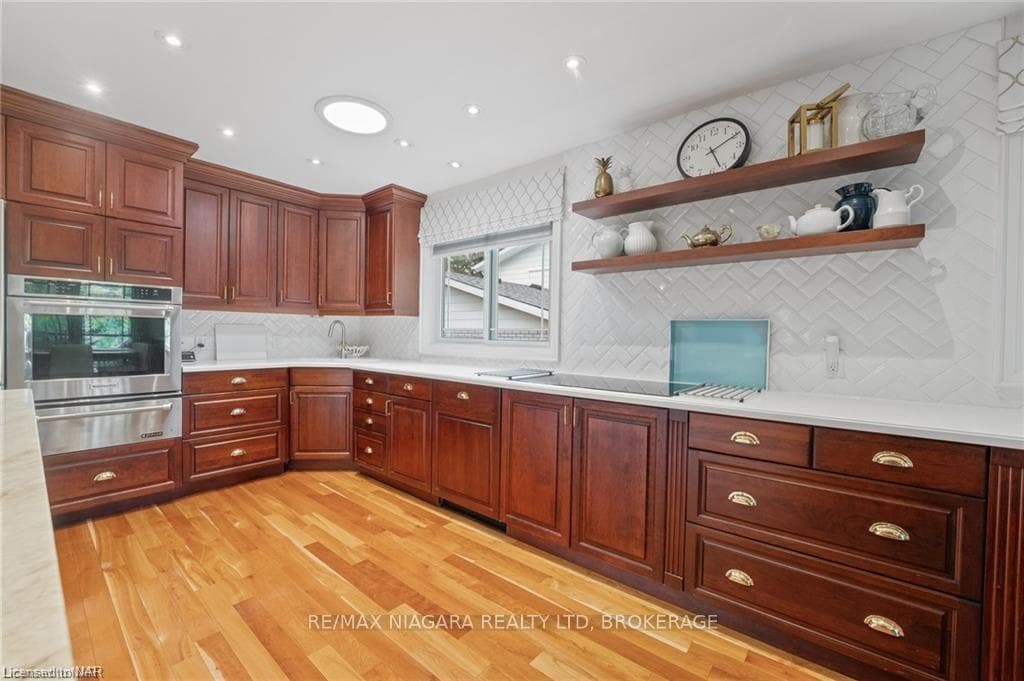 Kitchen featuring black electric stovetop, decorat
