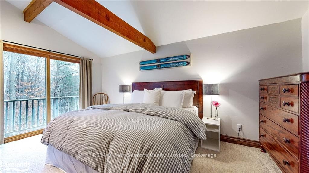 Bedroom with light colored carpet, access to exter