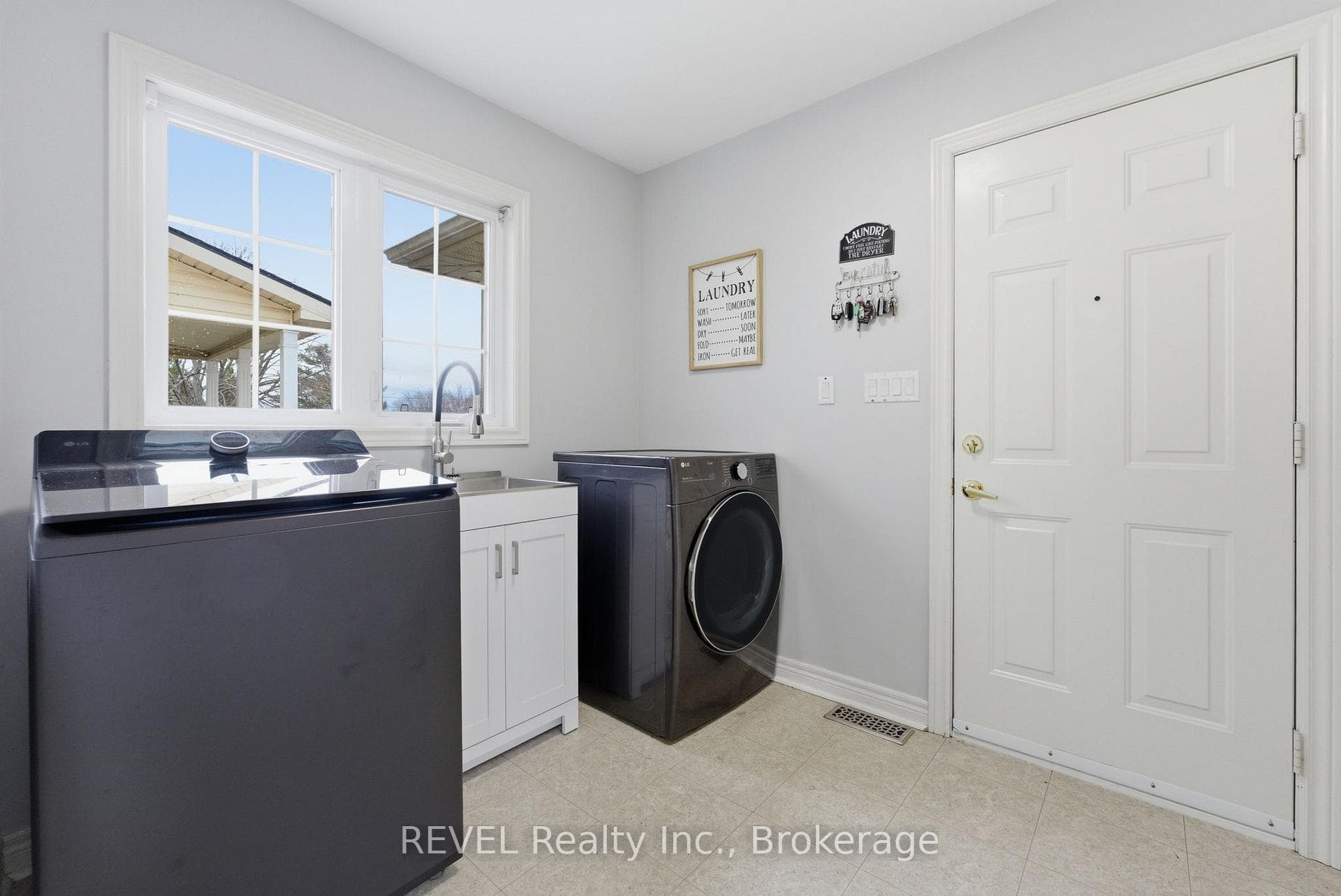LAUNDRY ENTRANCE TO GARAGE & LEADS TO LOFT