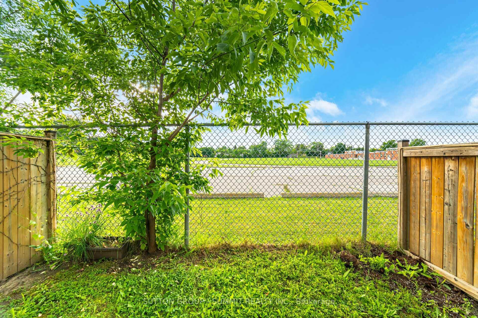 Fenced backyard backing on running track