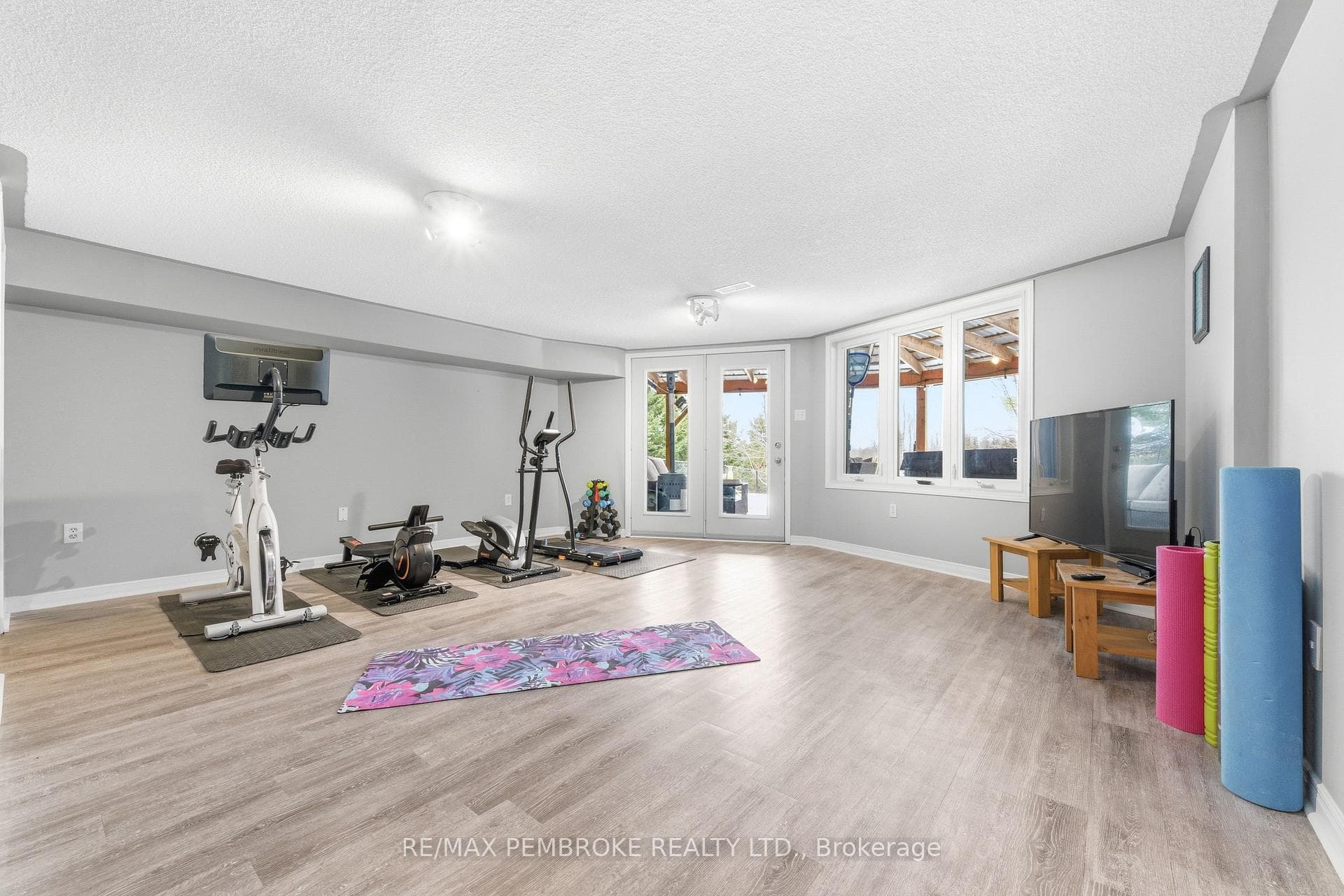 Gym setup with doors that walk out to the back