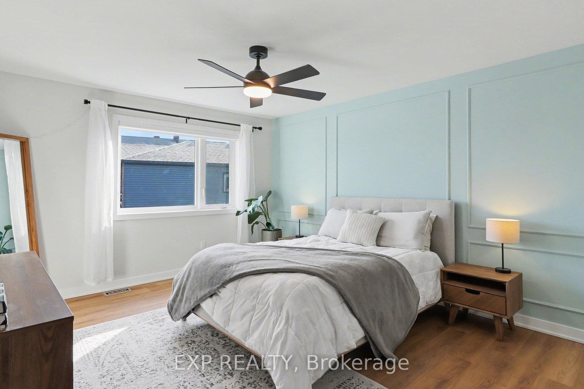 Primary bedroom with luxury vinyl plank flooring.