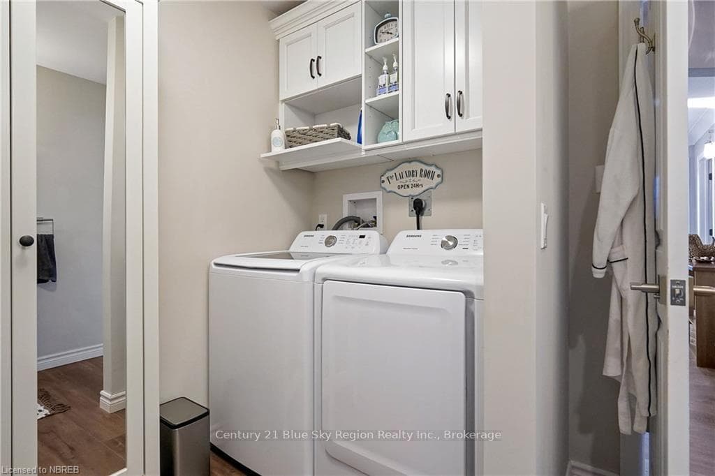 Laundry room featuring cabinets, washer and dryer,